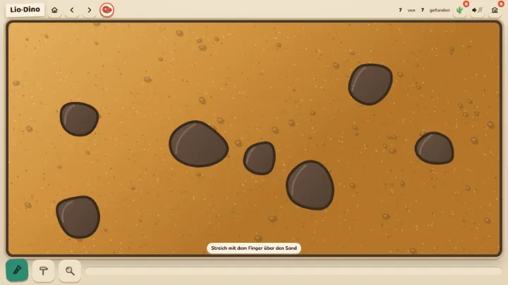 A field of sand with dark rocks; brush, hammer and magnifier below